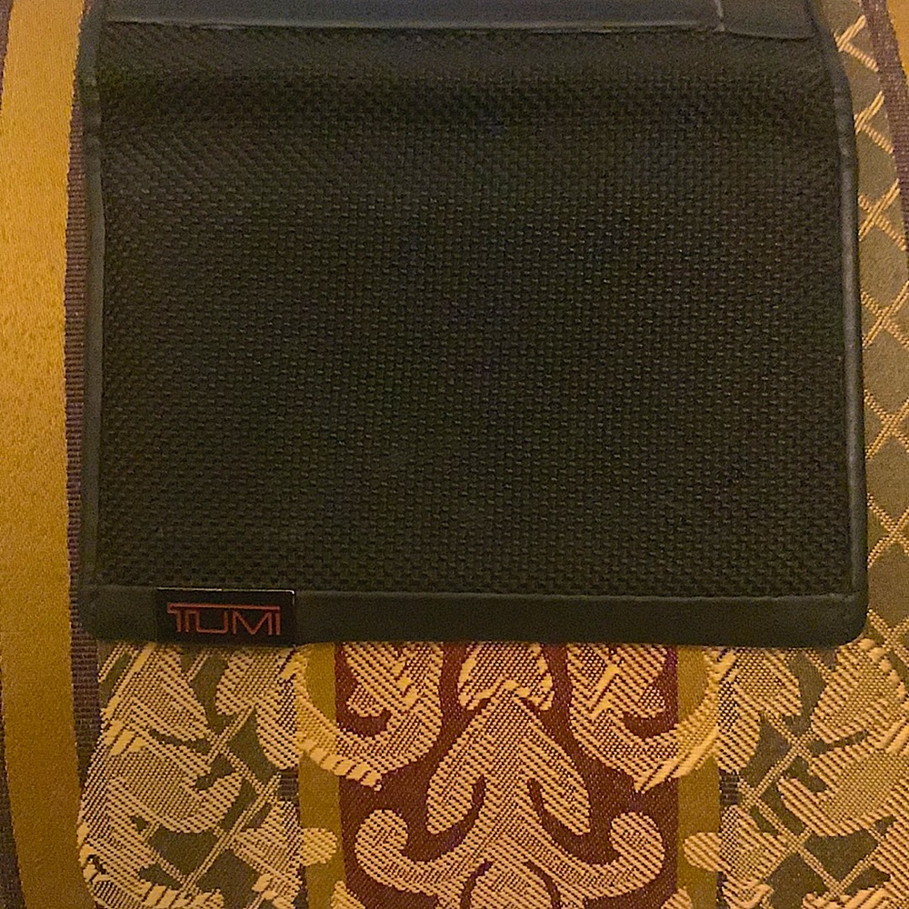 Tumi black canvas with leather, trim, bifold, wallet